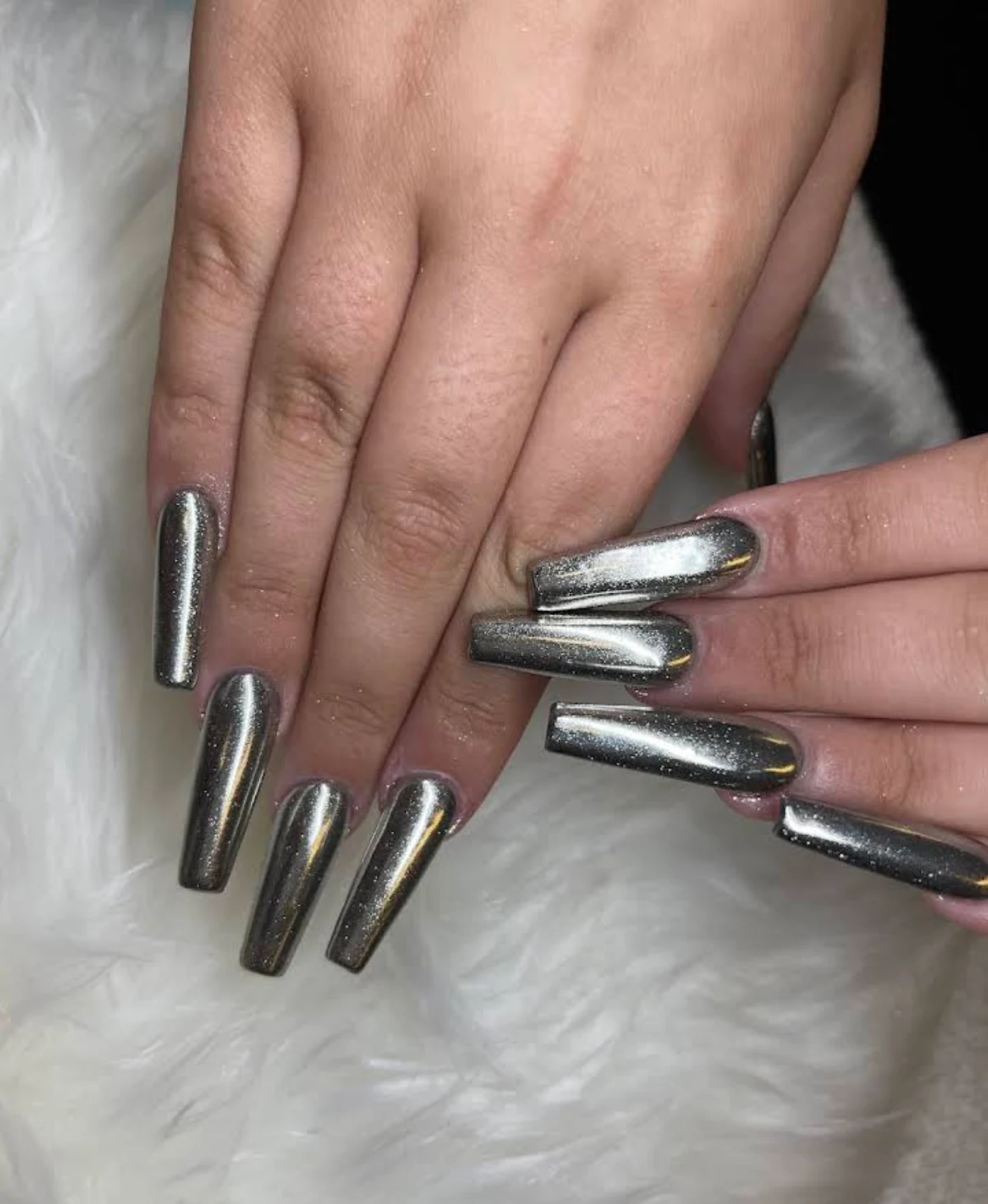 Long square nails with a reflective silver finish